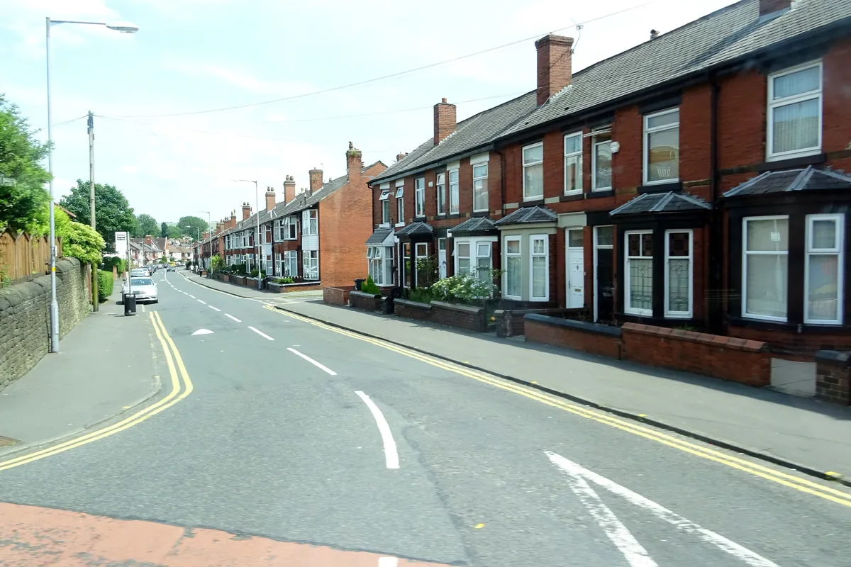 Red-brick terraced houses with bay windows on Ashworth Lane in Astley Bridge