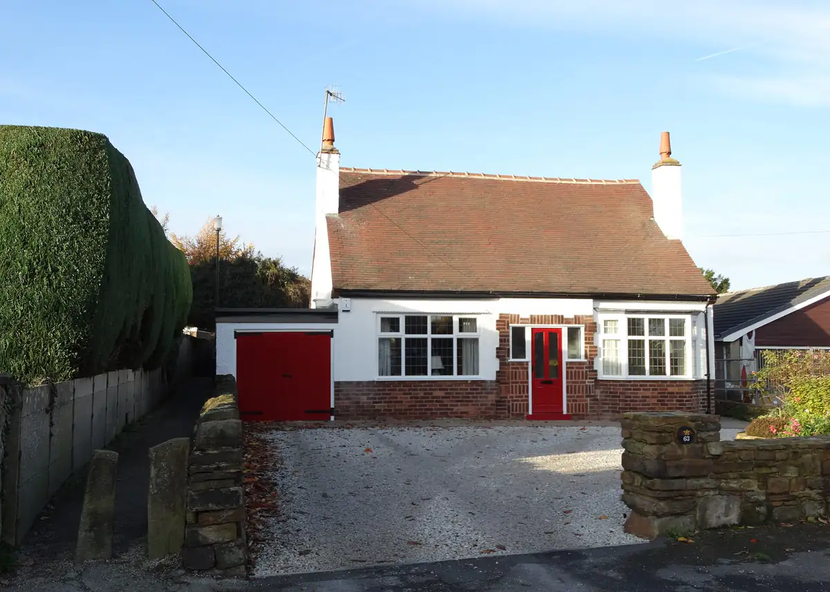 A white bungalow with a red door on Foljambe Avenue in Walton, Chesterfield