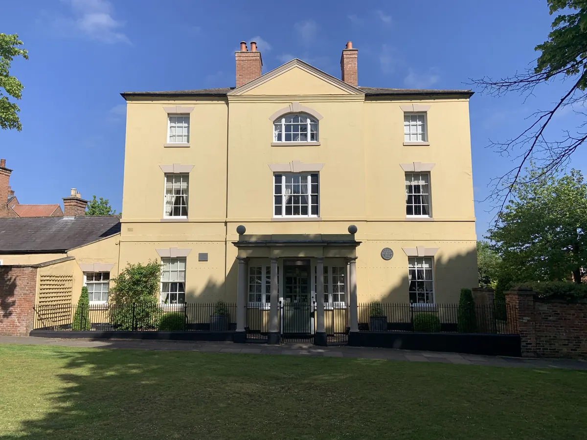 Burgage Manor, a pale Georgian house facing the green in Southwell
