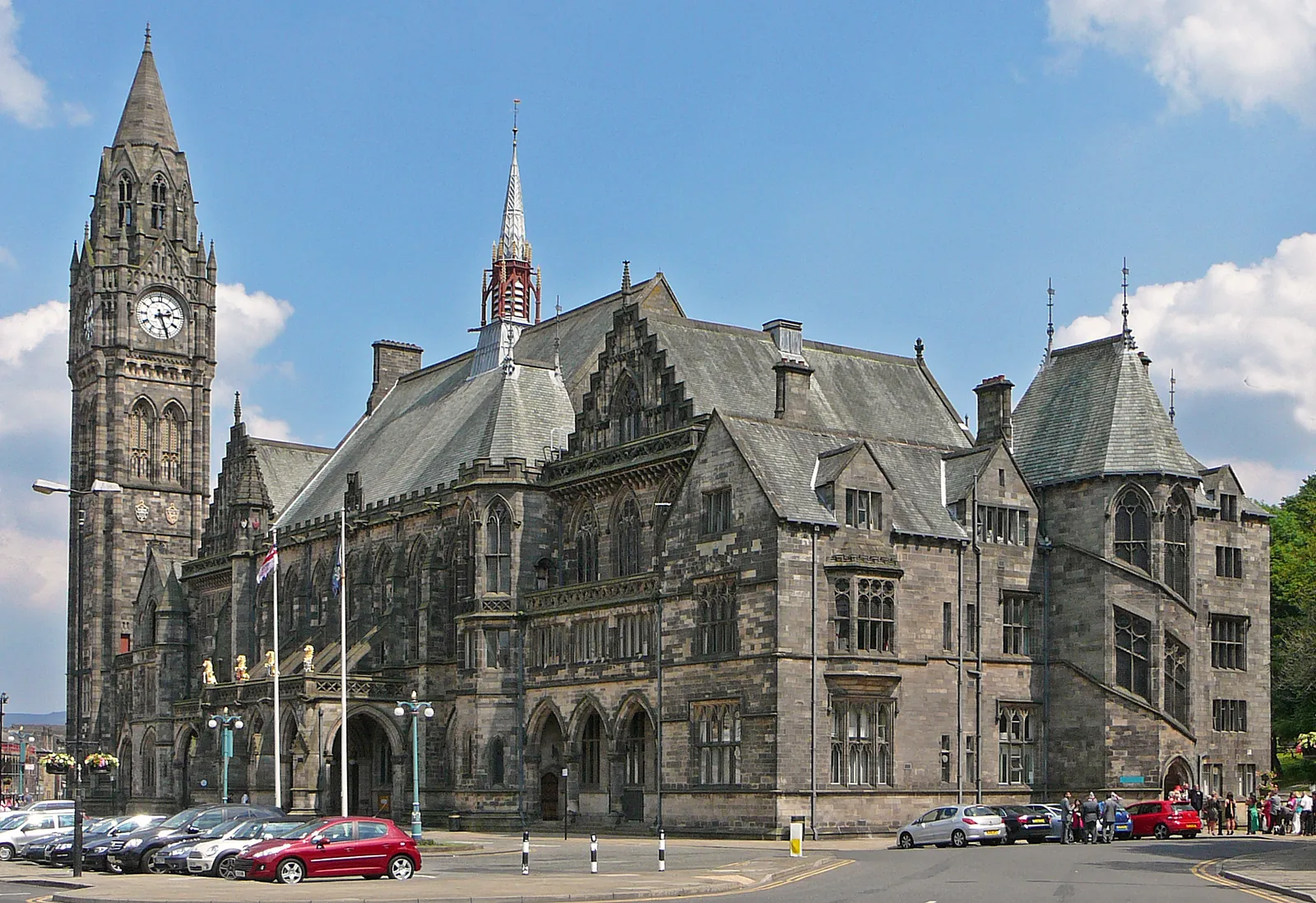 The Gothic front and clock tower of Rochdale Town Hall under a blue sky
