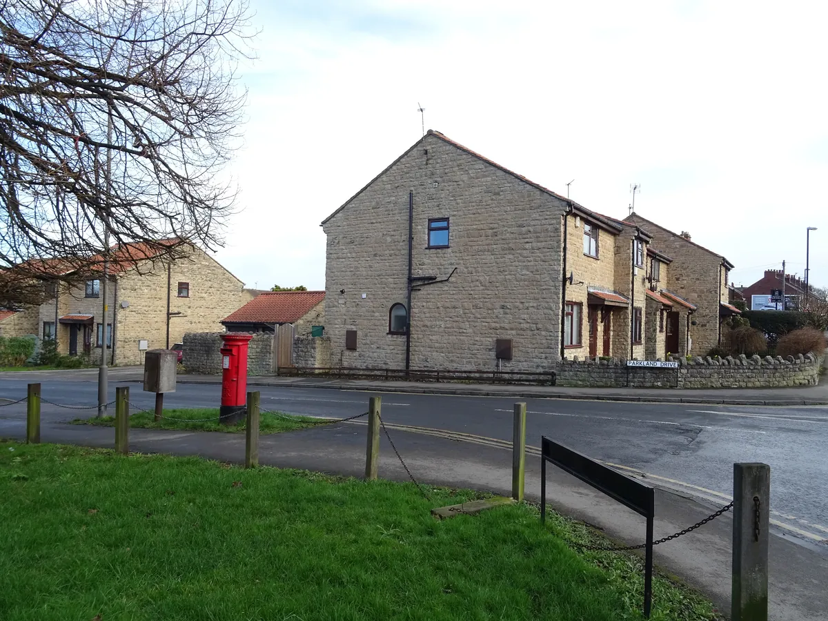 Pale stone houses on a corner of York Road in Tadcaster